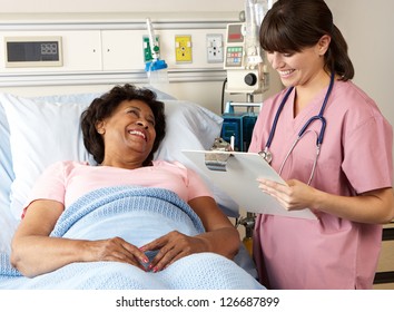 Nurse Visiting Senior Female Patient On Ward