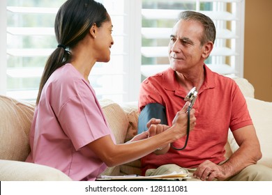 Nurse Visiting Senior Male Patient At Home