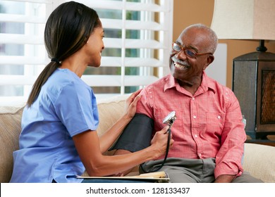 Nurse Visiting Senior Male Patient At Home