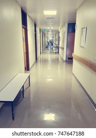 Nurse Walking Down A Hospital Hallway.