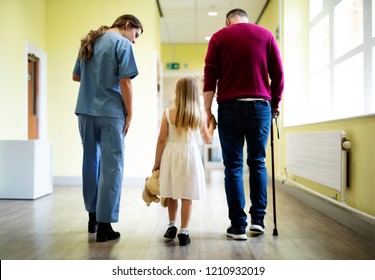 Nurse Walking A Patient Down The Hallway