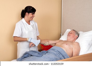 A Nurse Washes A Patient