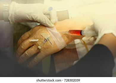 Nurse Wear Gloves Training Injection And Collecting Blood With Arm Model For Education At Hospital Or School Of Nursing: Soft Focus And Out Of Focus