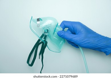 Nurse wearing medical gloves holding oxygen mask or simple mask. isolated on white - Powered by Shutterstock