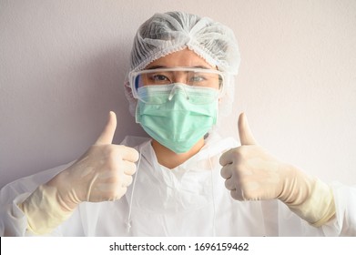 Nurse wearing PPE suit with mask for protect virus and showing thumbs up. In coronavirus pandemic outbreak we should support and encourage healthcare worker by stay home and listen to medical advice.