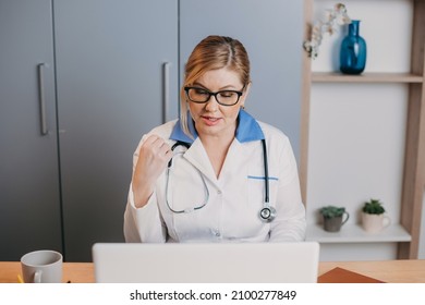 Nurse wears white coat and headset speaking videoconferencing on laptop computer. Online video call consultation app. Remote medical help for patient. Covid-19.