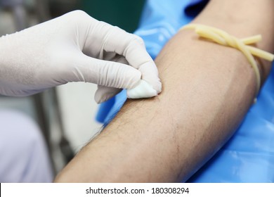 Nurse Wiping Her Female Patients With An Alcohol Swab.