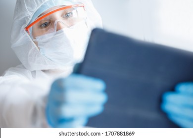 Nurse Woman In Quarantine Zone Of Hospital Calls Video Chat Online To Family, Coronavirus Pandemic. Web Connection Concept.