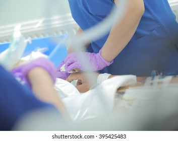 Nurse Working With Patient In ICU.