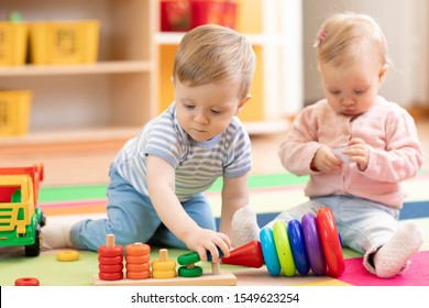 Nursery Babies Playing With Educational Toys In Creche, Early Learning