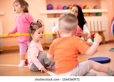 Nursery children with trainer in gym. Healthy lifestyle and child sport concept - Shutterstock ID 1564360972