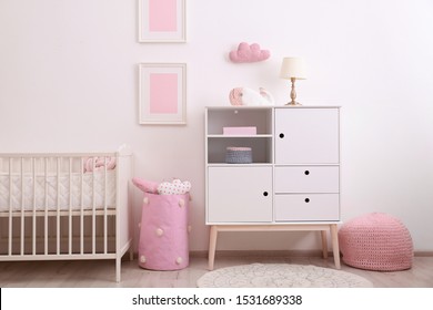 Nursery interior with comfortable bed and cabinet