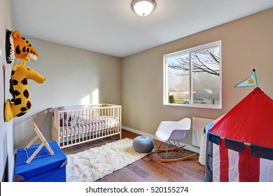 Nursery Room Interior With A Crib , Toys And Dark Hardwood Floor. Northwest, USA