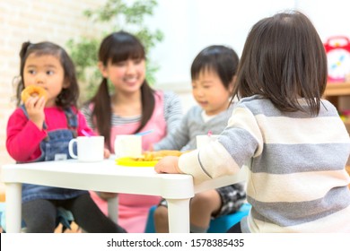 Nursery School Teacher And Snack Time