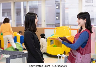 Nursery teacher having a conversation with parents