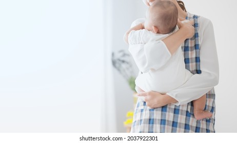 Nursery Teacher Holding A Baby
