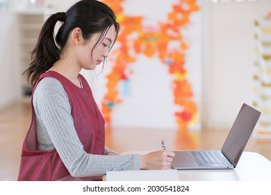 Nursery Teacher Writing A Diary