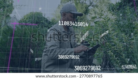 Nursery tech wearing cap and jacket holding tablet and scanning plants in nursery with AR IDs. Horticulture, agritech, fieldwork, outdoor, datadriven, augmentedreality, visualization