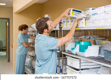 Nurses arranging stock in hospital storage room