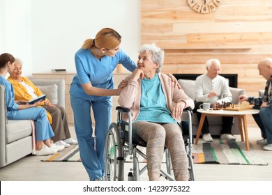 Nurses Assisting Elderly People At Retirement Home