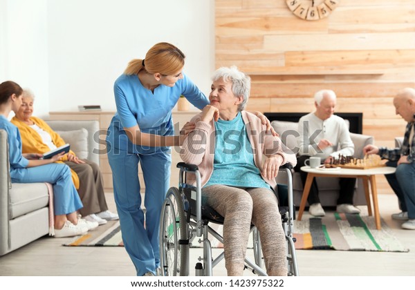 Nurses\
assisting elderly people at retirement\
home