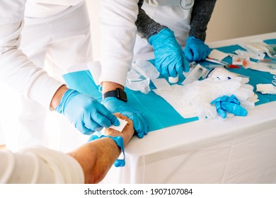 Nurses Caring For An Elderly Patient By Administering An Intravenous Medication