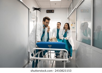 Nurses and doctors in a hurry taking patient to operation theatre. Patient on hospital bed pushed from surgeon and his team to emergency theatre. Team of doctors and surgeon rushing patient. - Powered by Shutterstock