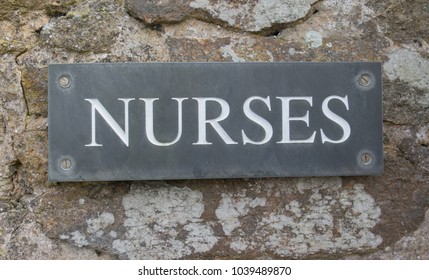 "Nurses" Engraved on a Flint Tile Attached to the Stone Wall of a Cottage on the Island of Tresco in the Isles of Scilly, England, UK