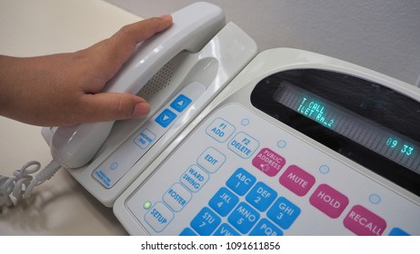 Nurse's Hand Holding Phone From Electronic Communication Equipment.Equipment For Nurse Or Staff When Patient Call For Help.