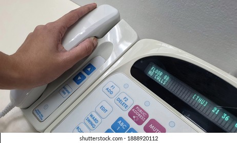 Nurse's Hand Holding Phone From Electronic Communication Equipment.Equipment For Nurse Or Staff When Patient Call For Help