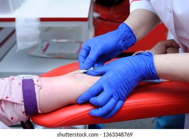 Nurse's Hands Taking Blood From The Vain Of A Donor - Hypodermic Needle, Tubes, Container With Blood