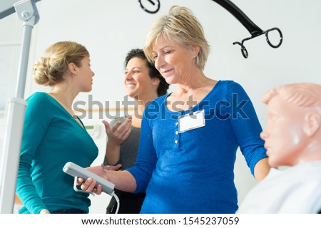 Similar – Female doctor talking to elderly patient in wheelchair