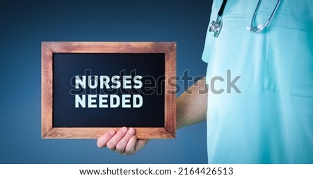 Nurses needed. Doctor shows sign (board) with wooden frame. Background blue