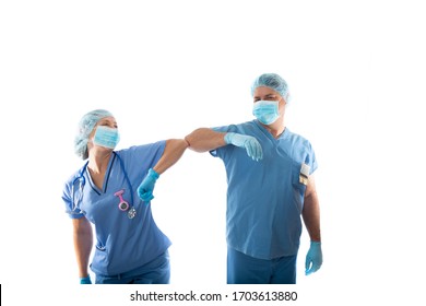 Nurses In Scrubs Elbow Bump Instead Of Shaking Hands During COVID-19 Influenza Pandemic