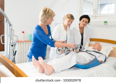nurses training to use equipment on mannequin