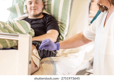 Nursing instructor demonstrating proper wound disinfection technique during clinical care training