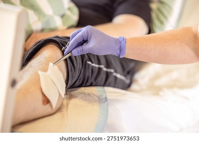 Nursing instructor demonstrating proper wound disinfection technique during clinical care training