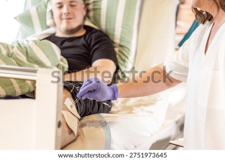 Nursing instructor demonstrating proper wound disinfection technique during clinical care training