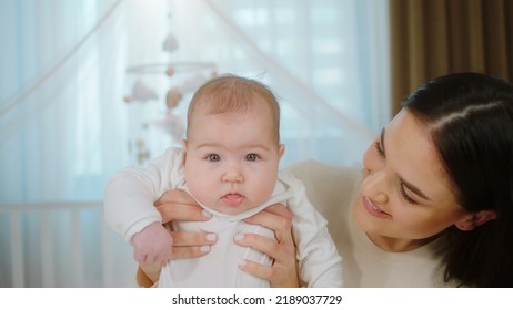 Nursing And Maternity Concept Pretty Baby Girl And Her Mother Speeding Time Together Laying Down On The Bed And Playing Together