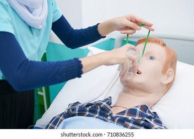 Nursing Student Are Practicing How To Provide Oxygen Administration To The Patient By A Doll Of Patient In The Simulation Of Virtual Presence In The Hospital.