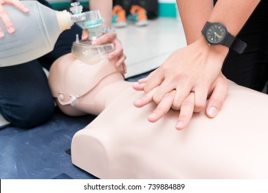 Nursing students are learning how to rescue the patient in emergency. CPR training with CPR doll. Closed-up. Soft focus.