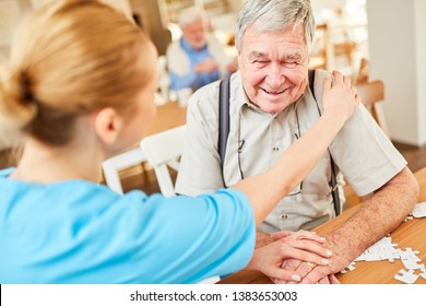 Nursing Woman Consoles A Senior With Dementia In Geriatric Care At Nursing Home