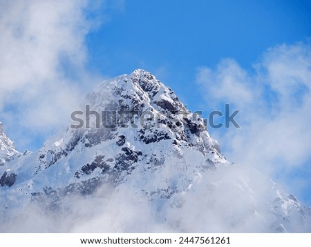 Nursultan Peak, old name Pioneer Peak. A peak in the Tien Shan Mountains near the city of Almaty. The snow-covered peak is shrouded in light cloud after a heavy snowfall