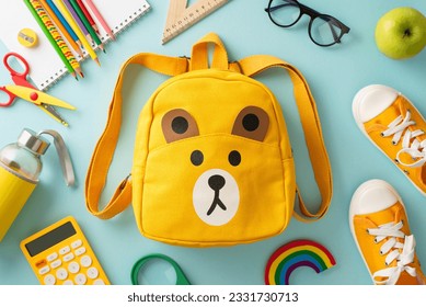 Nurturing bright minds. Overhead shot of a yellow child's rucksack with cartoon bear print packed with assorted colorful school materials and pair of shoes on a soft blue background - Powered by Shutterstock