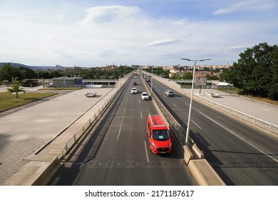 Nusle bridge, Prague, Czech Republic, Czechia - June 22, 2022: Cars and automobile are going on roadway in the center of capital  city. Traffic and transport in town. Wide angle distortion.