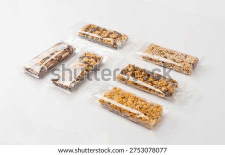 Nut Bar in Plastic Package Isolated, Energy Snack with Nuts, Muesli, Protein Candy Bar, Fitness Fruit and Nut Mix on White Background, Clipping Path