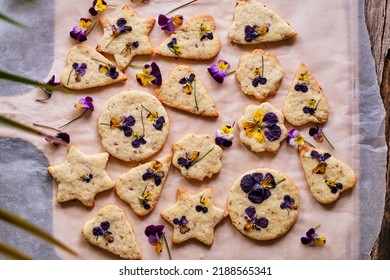 Nut Cookies with edible flowers. Viola, top view, wooden background - Powered by Shutterstock