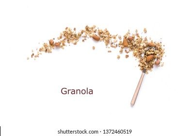 Nut Granola on spoon isolated on white background, copy space. Healthy snack or breakfast concept - homemade granola with grains and nuts.
