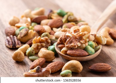 Nut mix on wooden spoon, Assorted and various of nuts. - Powered by Shutterstock