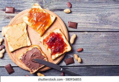 nut nougat cream with chocolate , strawberry, apricot jam and peanut butter sandwich .